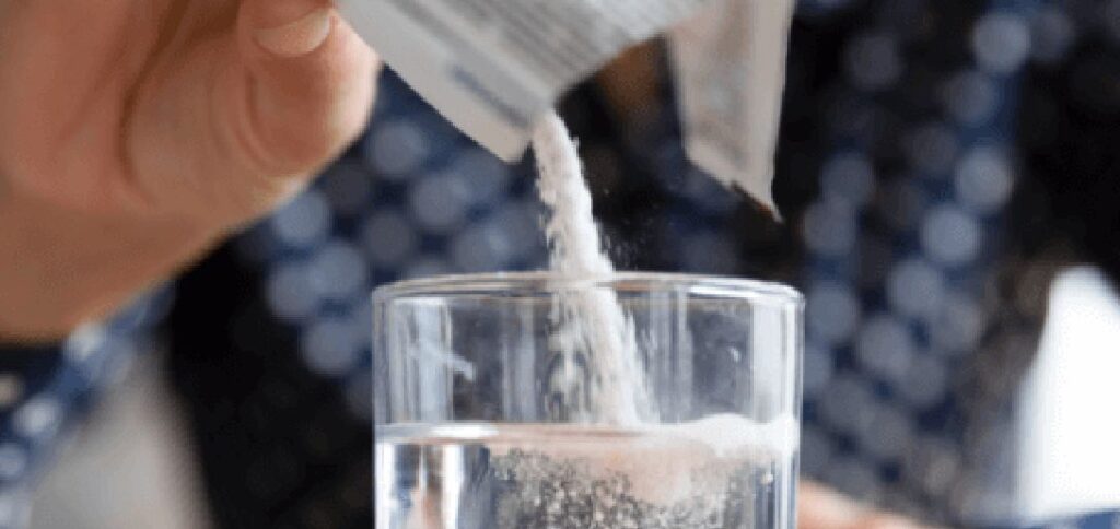 Pouring a Sachet of Powder into a Drink